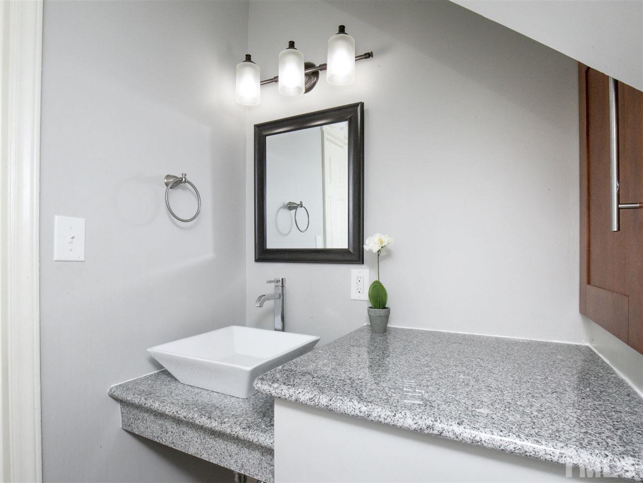 2542 Noble Road Raleigh, NC 27608 - Photo 8 of 27 a bathroom with a granite countertop sink and a mirror