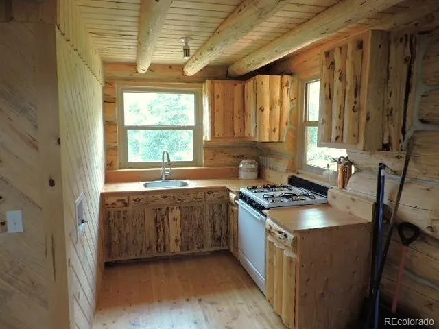 a kitchen with a stove a sink and a refrigerator