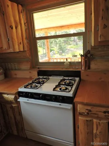 a kitchen with a stove and a window