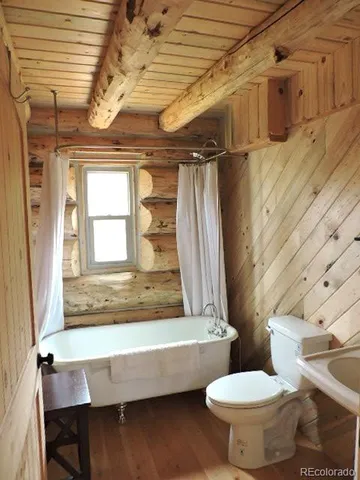 a bathroom with a toilet sink and bathtub