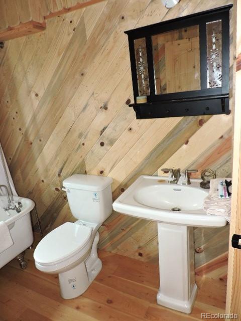 6548 Giesse Road San Luis, CO 81152 - Photo 22 of 45 a bathroom with a toilet sink and mirror