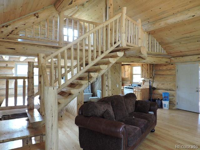 6548 Giesse Road San Luis, CO 81152 - Photo 29 of 45 a living room with lots of furniture and a chandelier
