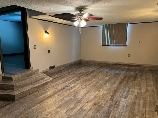 a view of a livingroom with a ceiling fan and window
