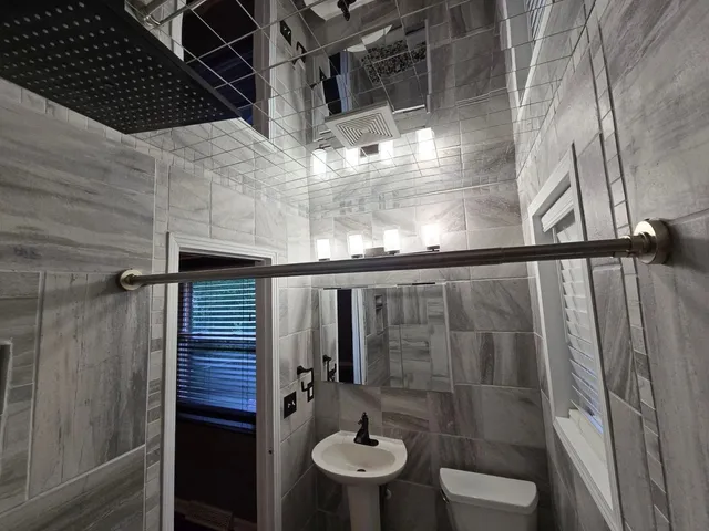 a bathroom with a shower and toilet