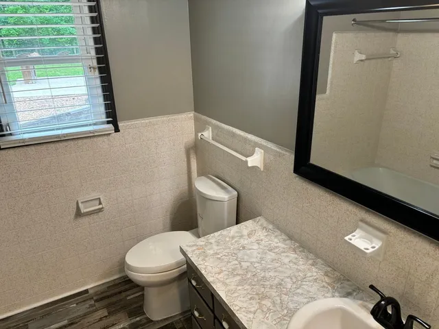 a bathroom with a toilet and a sink