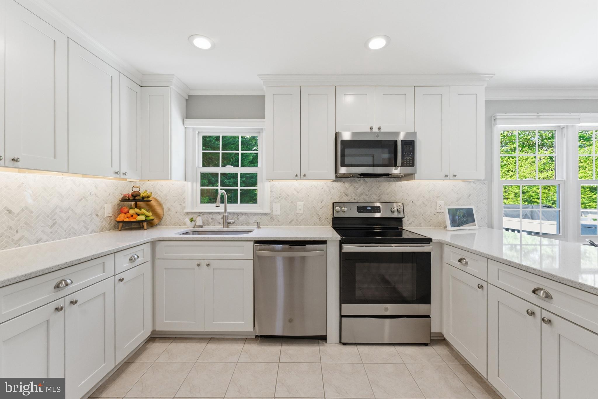 6445 Linway Terrace McLean, VA 22101 - Photo 14 of 46 a kitchen with granite countertop a stove sink and cabinets