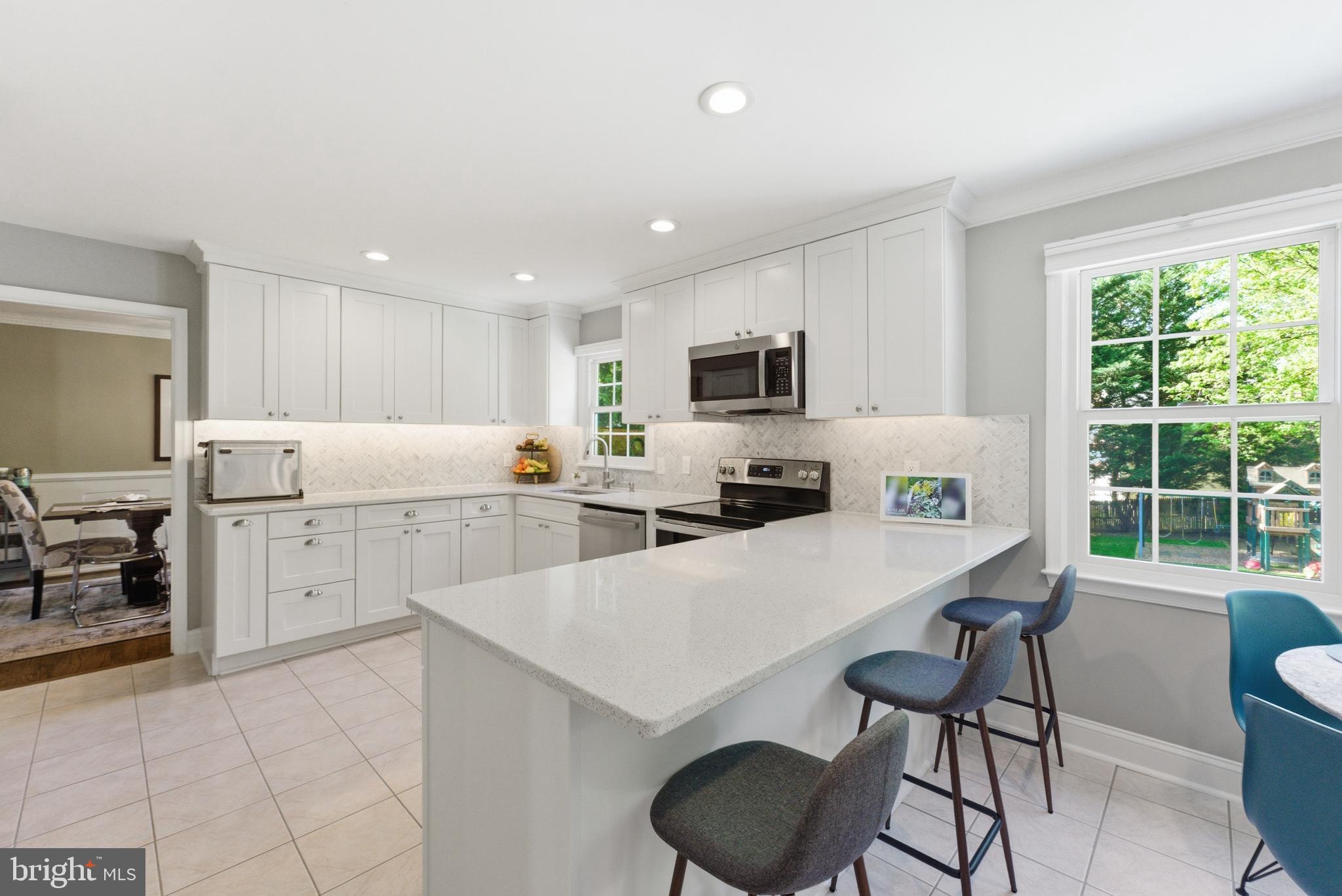 6445 Linway Terrace McLean, VA 22101 - Photo 16 of 46 a kitchen with a sink a stove a refrigerator cabinets and chairs