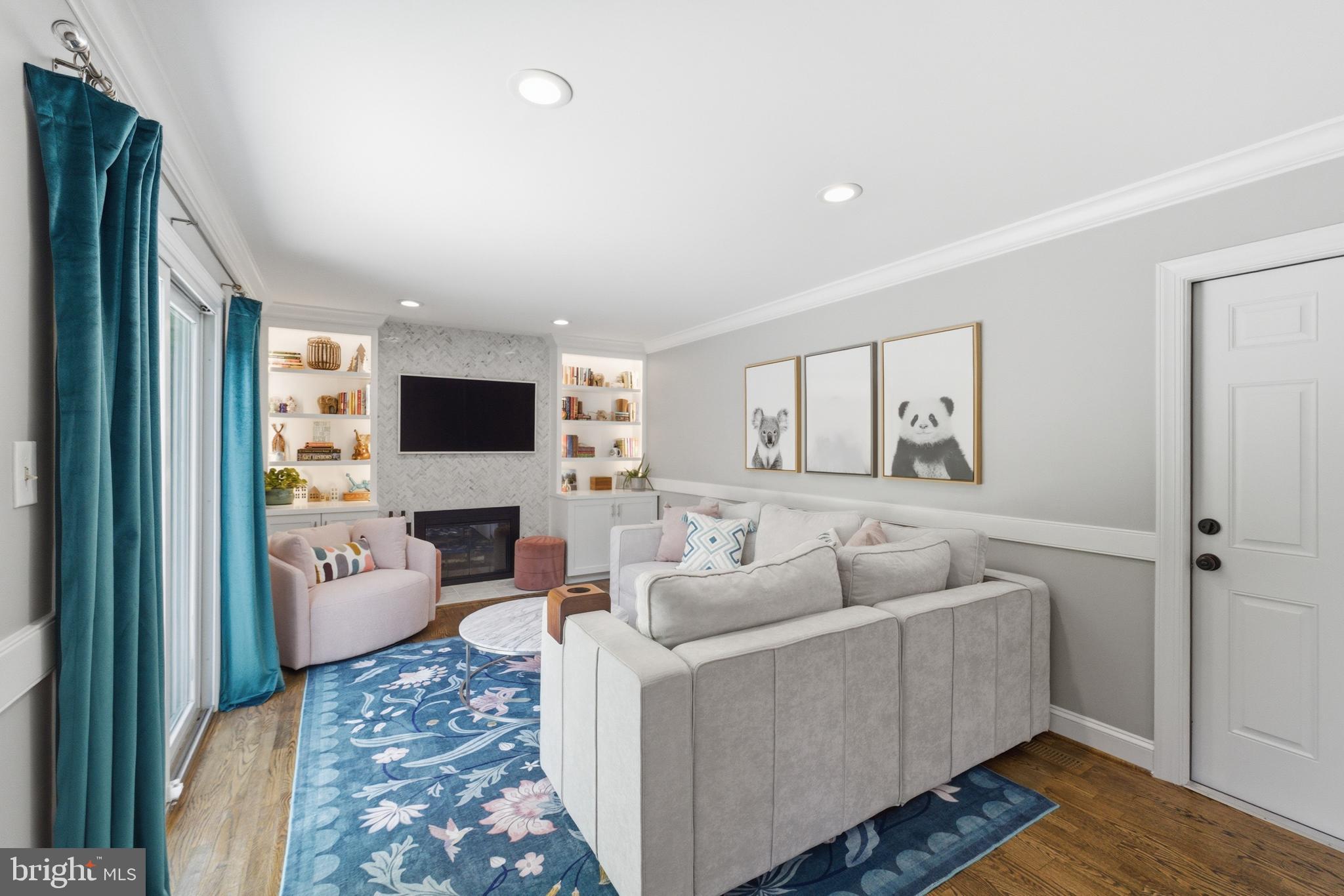 6445 Linway Terrace McLean, VA 22101 - Photo 20 of 46 a living room with furniture a flat screen tv and a fireplace