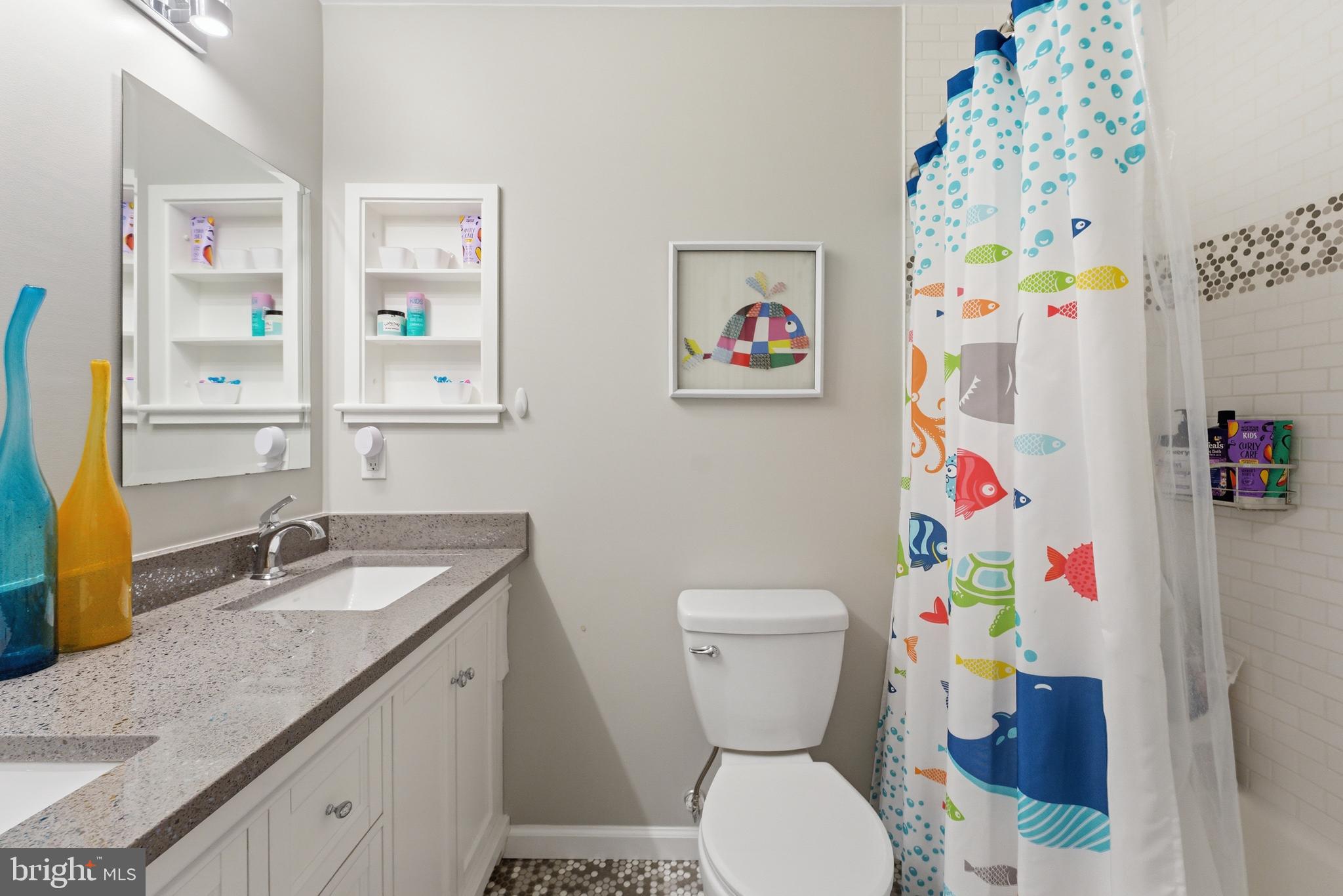 6445 Linway Terrace McLean, VA 22101 - Photo 33 of 46 a bathroom with a granite countertop toilet sink and mirror