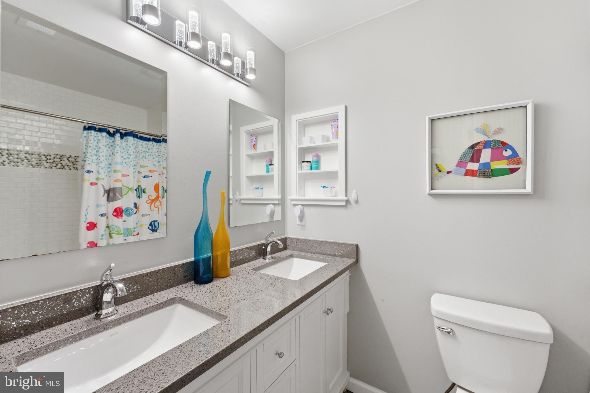 6445 Linway Terrace McLean, VA 22101 - Photo 34 of 46 a bathroom with a sink a toilet and a mirror
