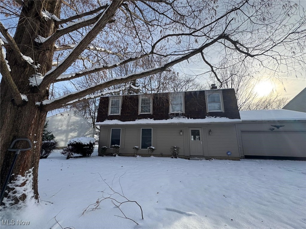 17073 Drake Road Strongsville, OH 44136 - Photo 48 of 50 Snow covered house with an attached garage and a chimney