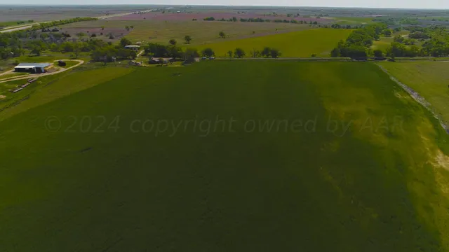 an aerial view of a houses with a lake