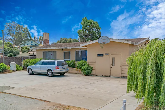 front view of a house with a cars park