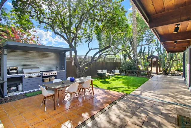 a view of an house with backyard porch and sitting area