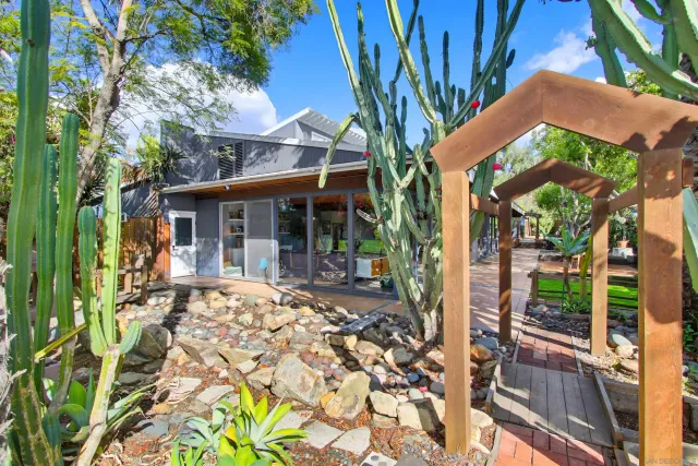 a view of a patio with table and chairs and potted plants