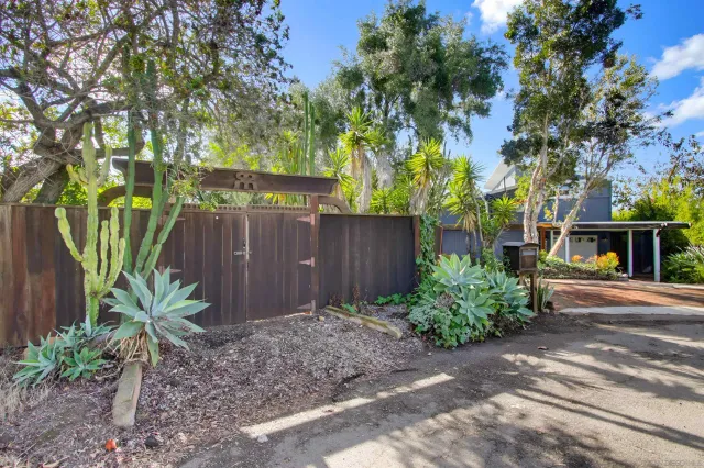 a backyard of a house with table and chairs