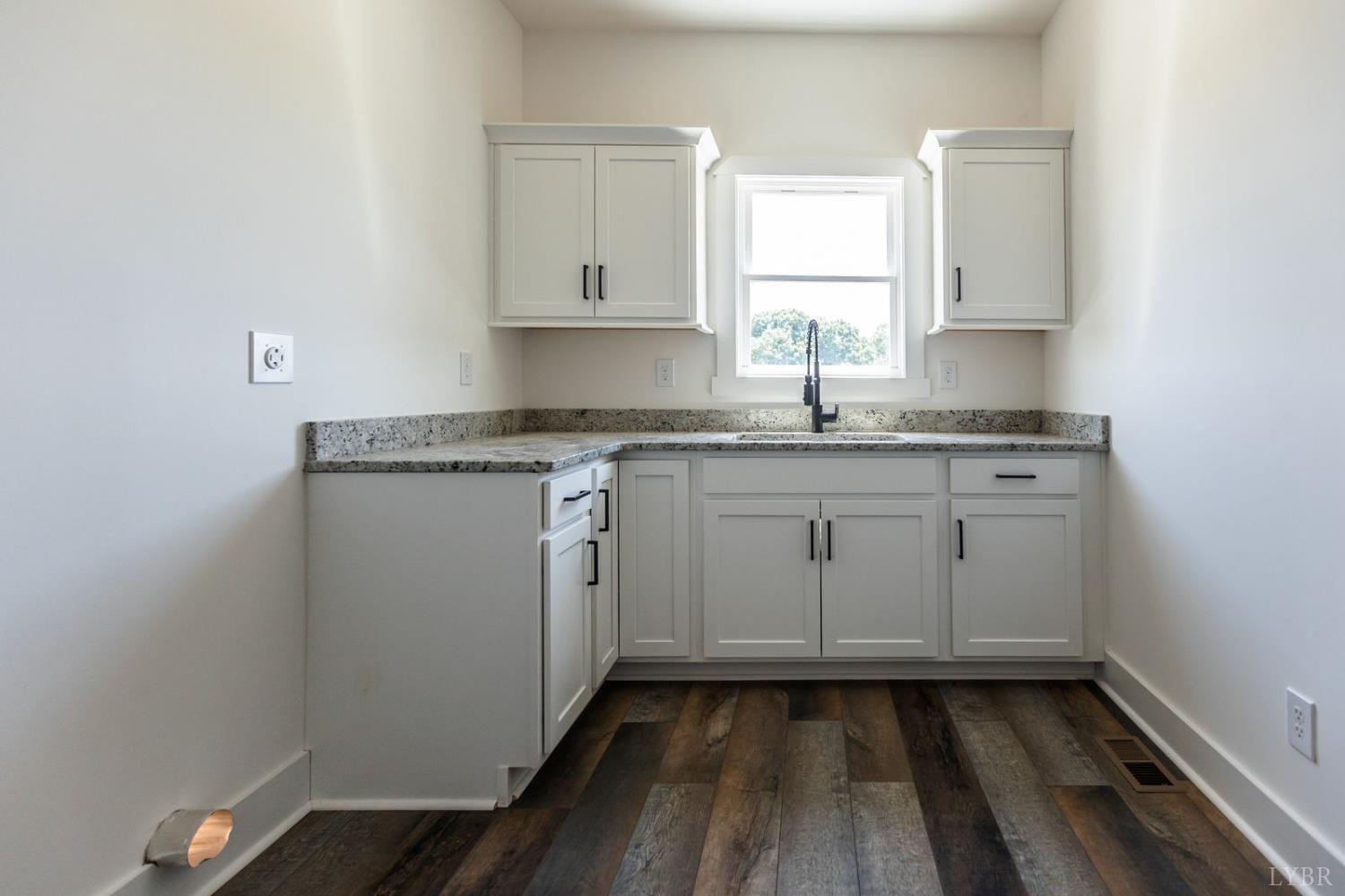 9740 Oakville Road Gladstone, VA 24553 - Photo 42 of 75 a kitchen with a sink a stove cabinets and wooden floor