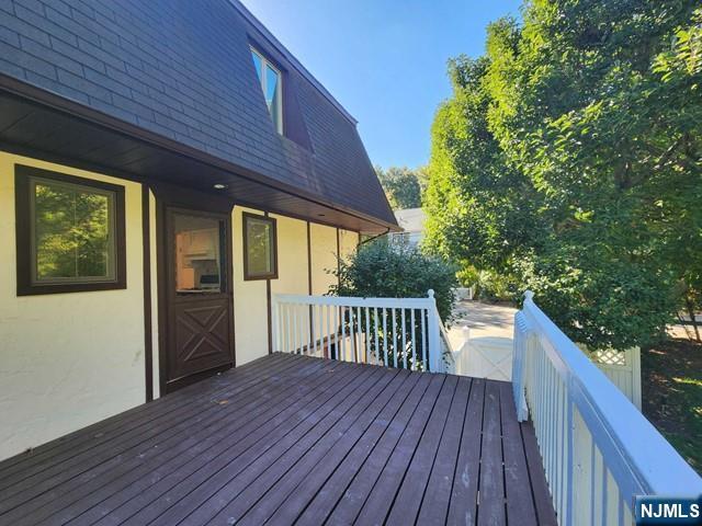 26 7th Street, Unit B Cresskill, NJ 07626 - Photo 21 of 26 a view of backyard with a deck and wooden floor