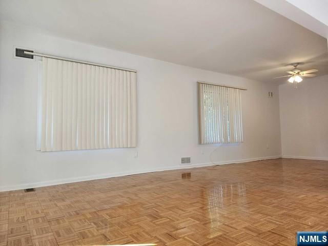 26 7th Street, Unit B Cresskill, NJ 07626 - Photo 7 of 26 a view of an empty room with window and chandelier fan