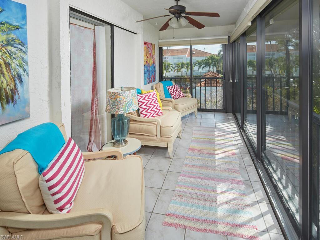 415 10th Avenue South, Unit 7 Naples, FL 34102 - Photo 13 of 15 a living room with furniture and a large window