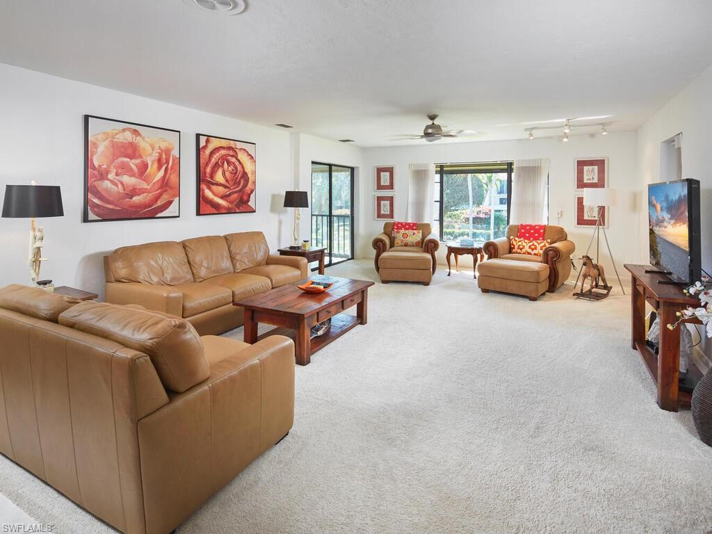 415 10th Avenue South, Unit 7 Naples, FL 34102 - Photo 3 of 15 a living room with furniture and a flat screen tv