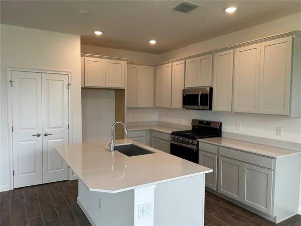 a kitchen with a sink a stove and refrigerator