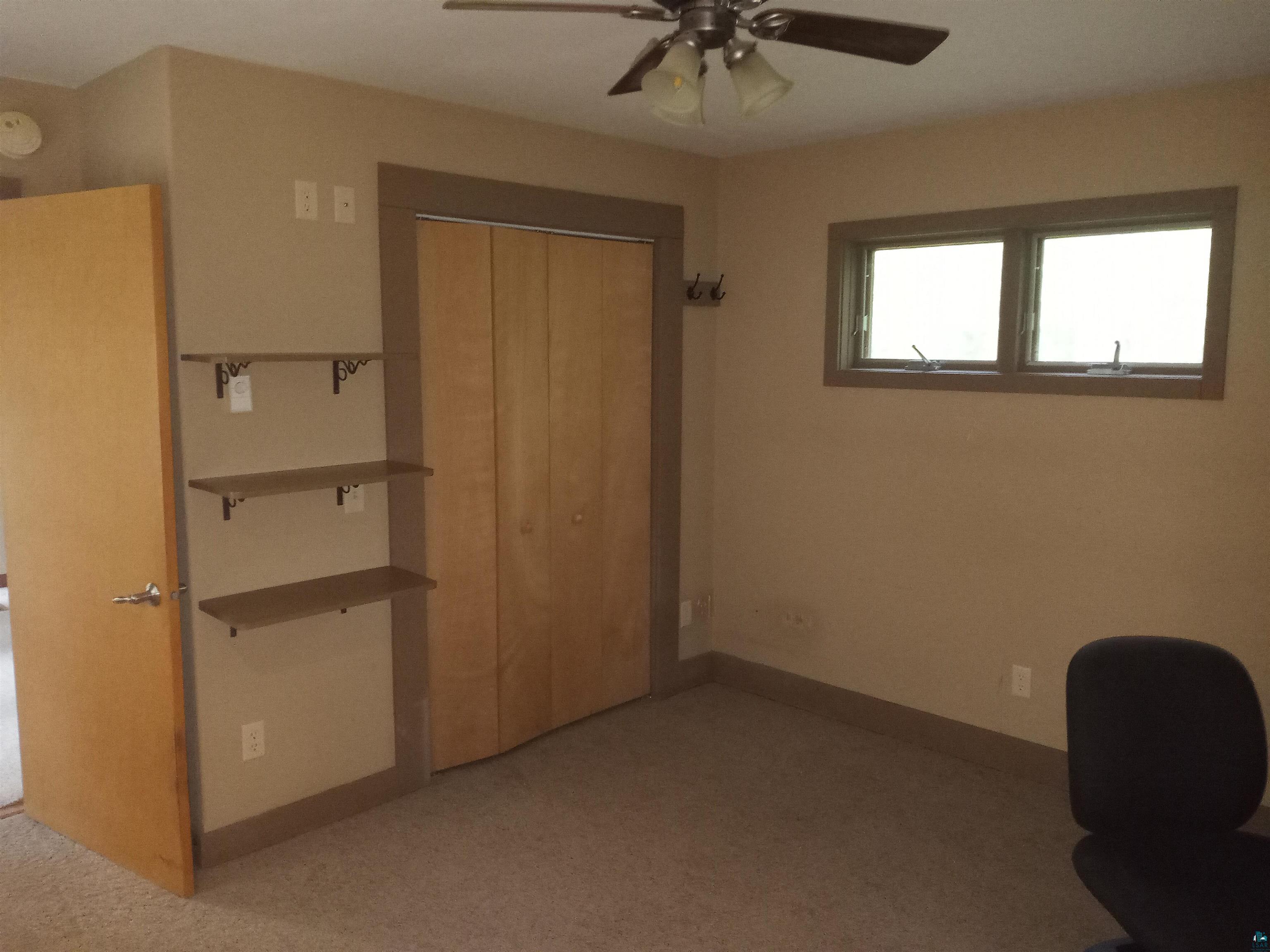 22715 Elm Street Cornucopia, WI 54827 - Photo 17 of 23 Master bedroom with ceiling fan.
