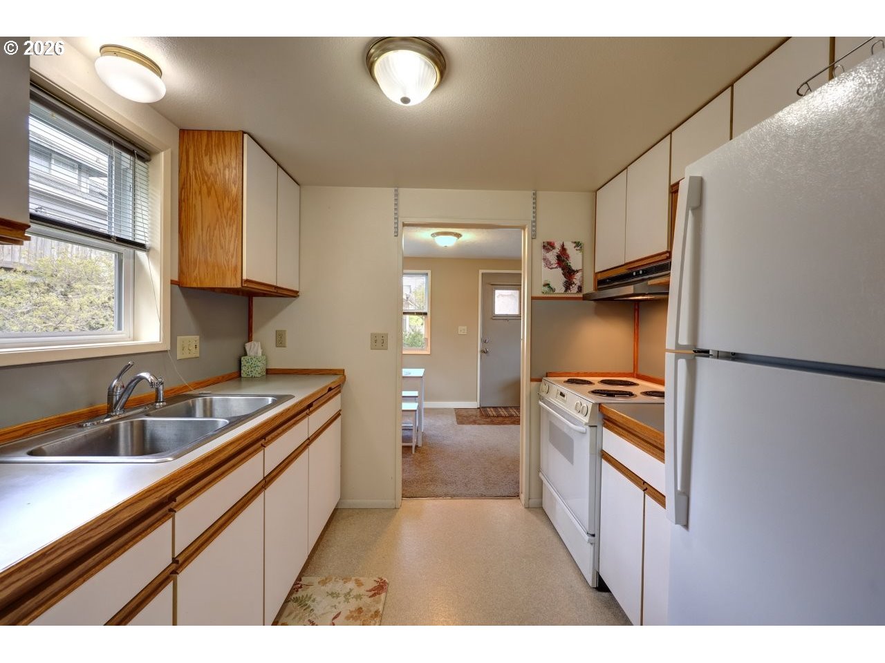 1449 9th Street Astoria, OR 97103 - Photo 12 of 20 a kitchen with stainless steel appliances granite countertop a sink stove and refrigerator