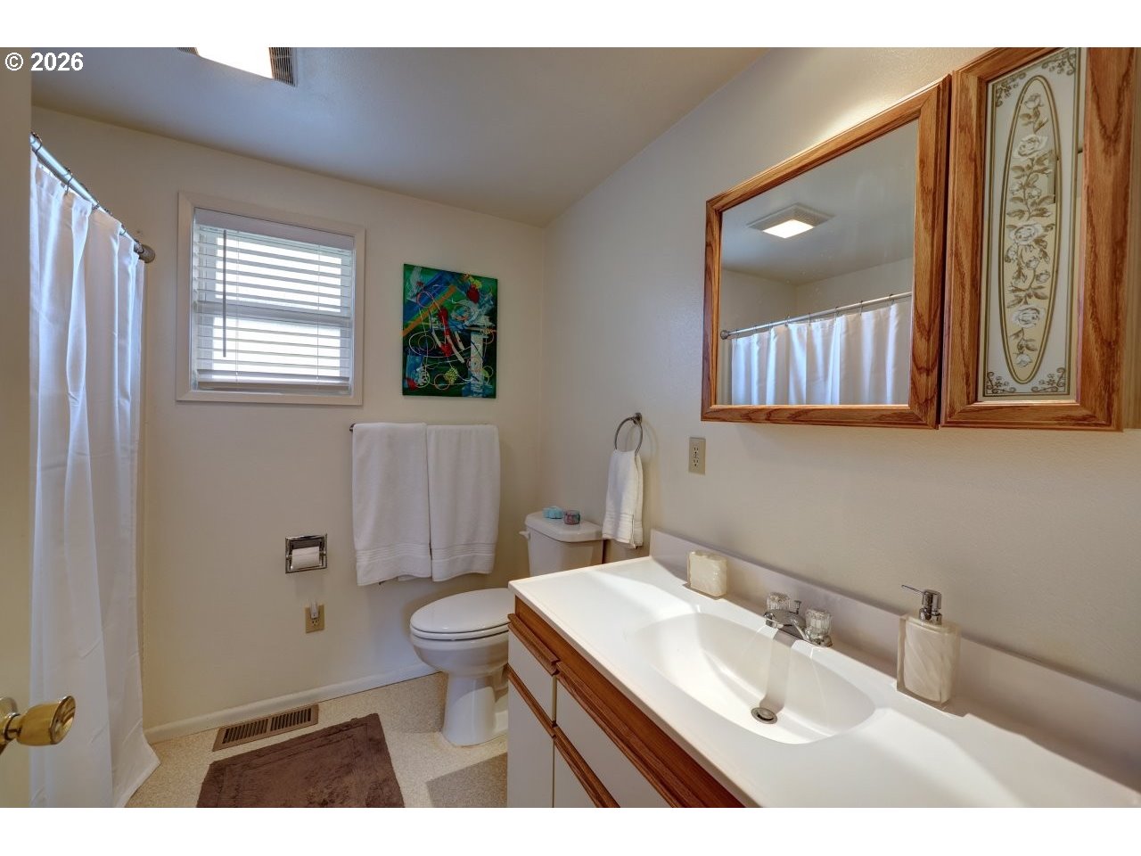 1449 9th Street Astoria, OR 97103 - Photo 14 of 20 a bathroom with a sink a toilet and mirror