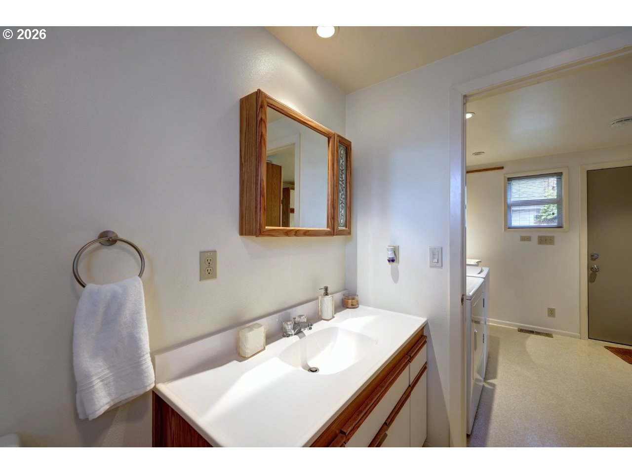 1449 9th Street Astoria, OR 97103 - Photo 15 of 20 a bathroom with a sink vanity and a mirror