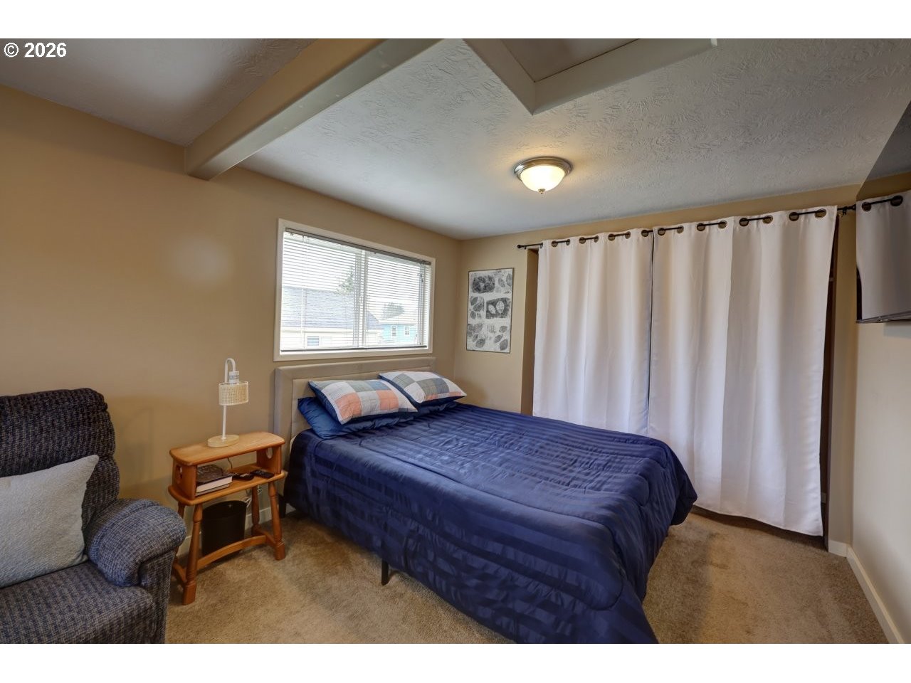 1449 9th Street Astoria, OR 97103 - Photo 7 of 20 a bedroom with a bed and a window