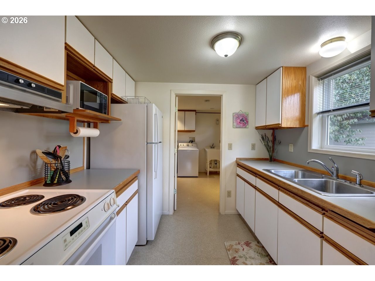 1449 9th Street Astoria, OR 97103 - Photo 9 of 20 a kitchen with stainless steel appliances granite countertop a sink stove and refrigerator