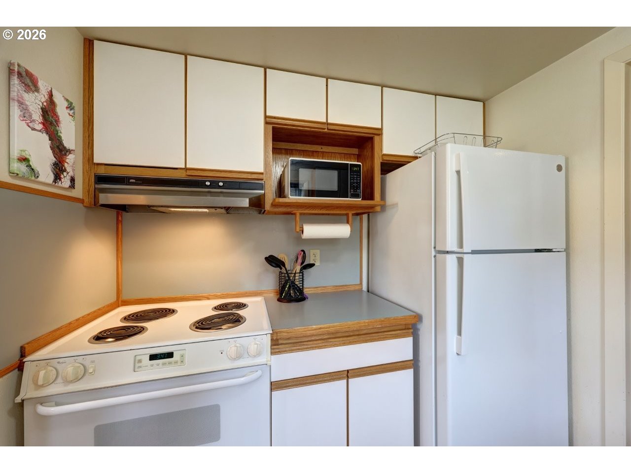 1449 9th Street Astoria, OR 97103 - Photo 10 of 20 a kitchen with a refrigerator and a stove top oven