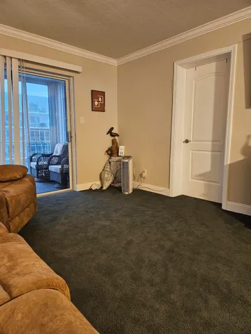 a bed sitting in a bedroom next to a lamp