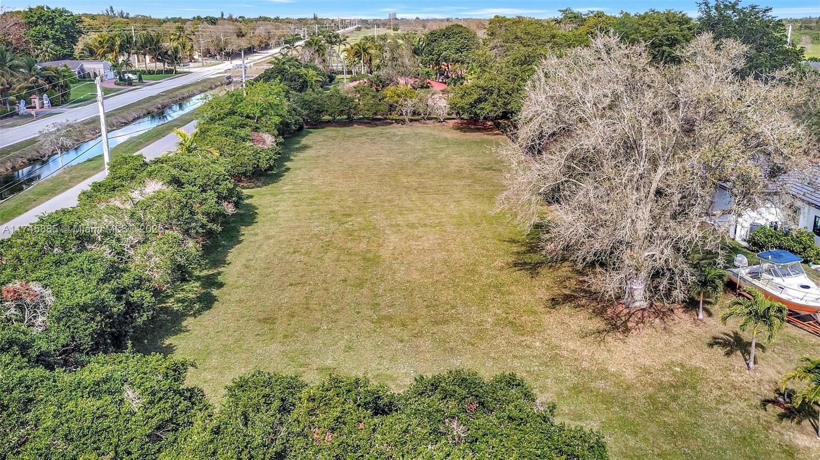 28 Sw Street Davie, FL 33330 - Photo 2 of 11 a view of a garden with plants and large trees