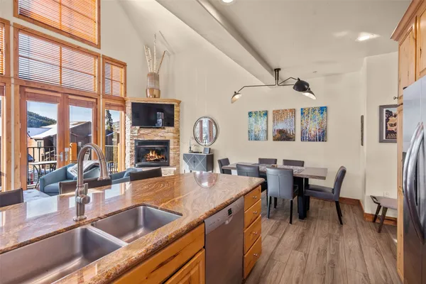 a kitchen with stainless steel appliances granite countertop a sink and wooden cabinets
