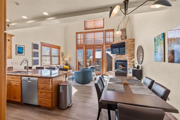 a living room with furniture a flat screen tv and kitchen view