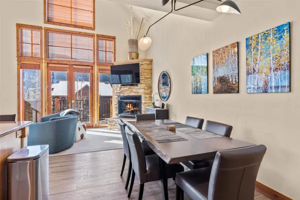 a view of a dining room with furniture large window and wooden floor