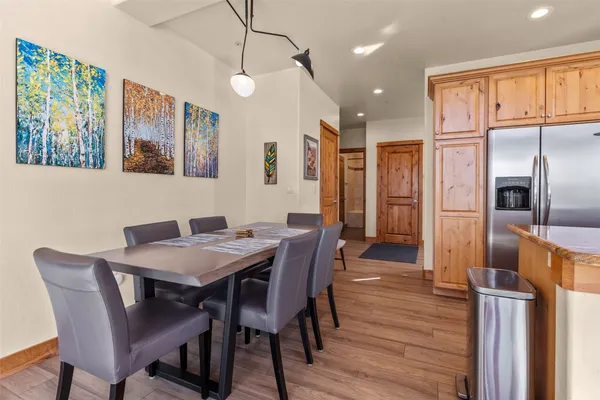 a view of a dining room with furniture large window and wooden floor