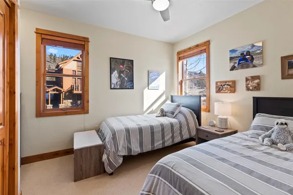 a bedroom with two beds and painting on the wall