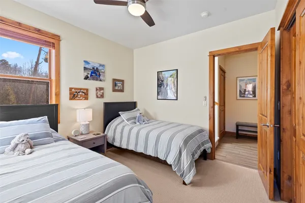 a bedroom with two beds and a chandelier