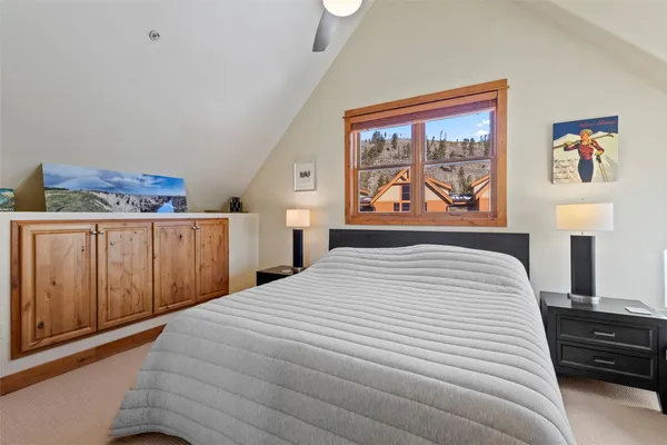 a large bed in a bedroom next to a window