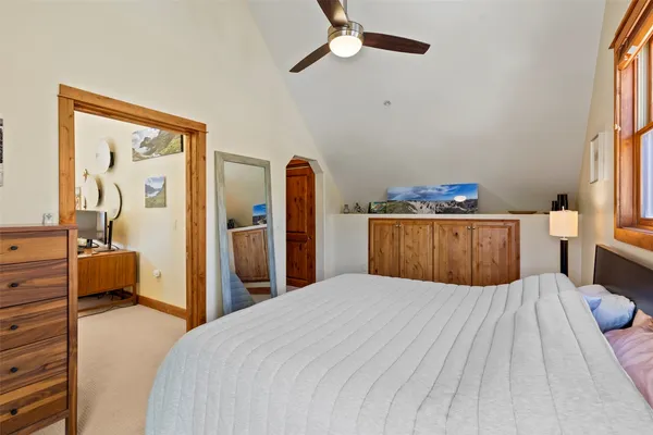 a bedroom with a large bed and dresser