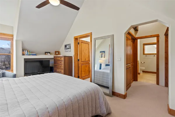 a bedroom with a large bed and a chandelier