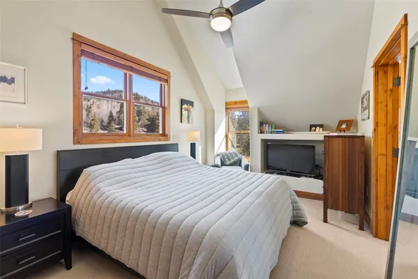 a bedroom with a bed dresser and a window