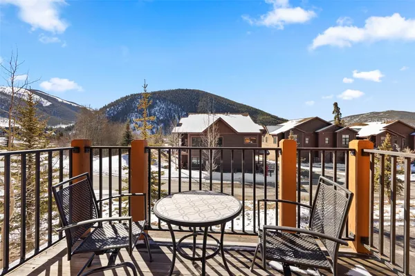 a view of a chairs and table in the balcony