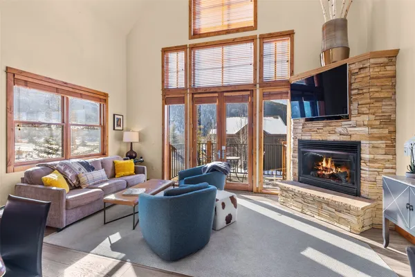 a living room with furniture a flat screen tv and a fireplace