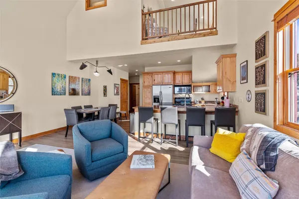 a living room with furniture and kitchen view