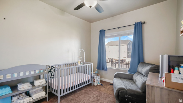 6062 Spring Street Stansbury Park, UT 84074 - Photo 16 of 36 Upstairs Bedroom featuring neutral wall tones, a ceiling fan with light fixture, a window with blue curtains, and brown carpet flooring