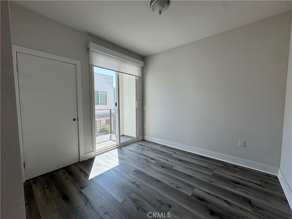 7958 Telegraph Road Downey, CA 90240 - Photo 16 of 38 a view of an empty room with wooden floor and a window